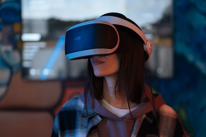 A woman wearing a vr headset and headphones.